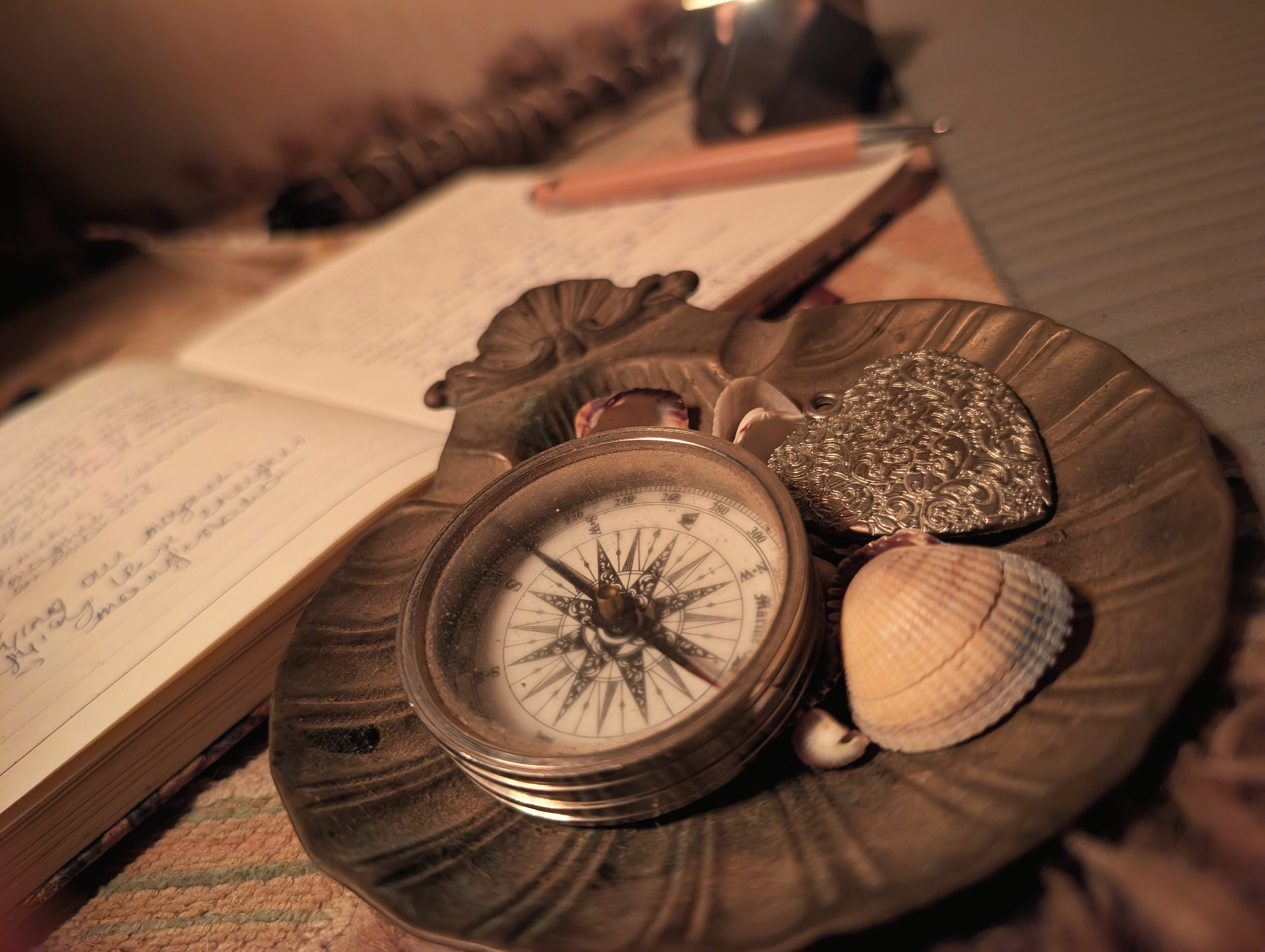 A compass resting beside an open journal