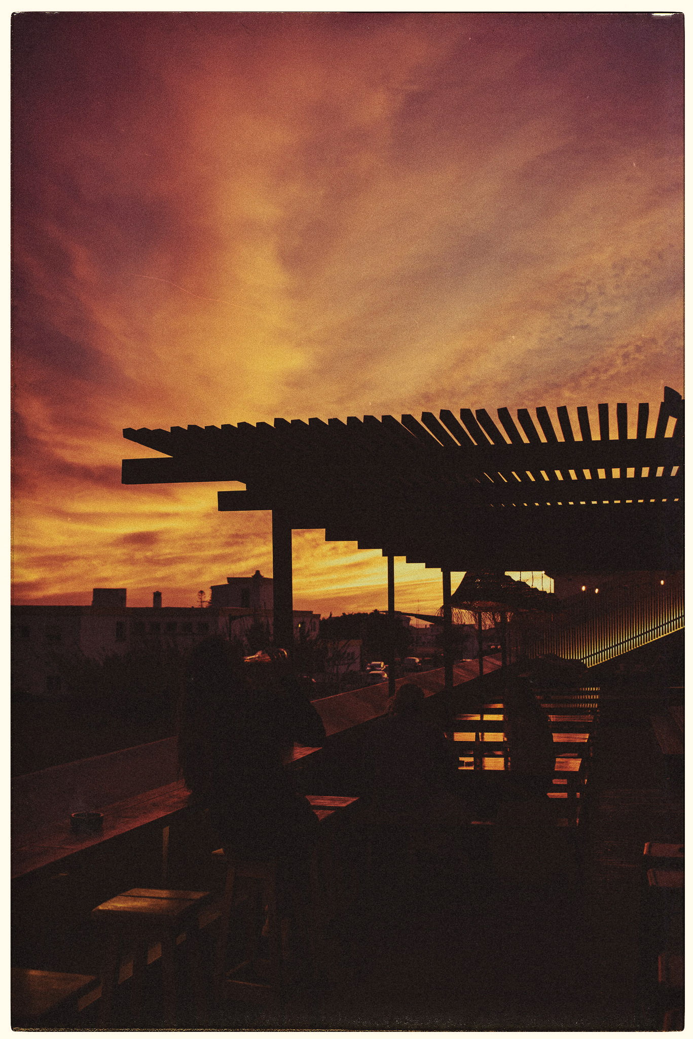 A pergola in silhouette against a burning sunset, by Igor Świeczak