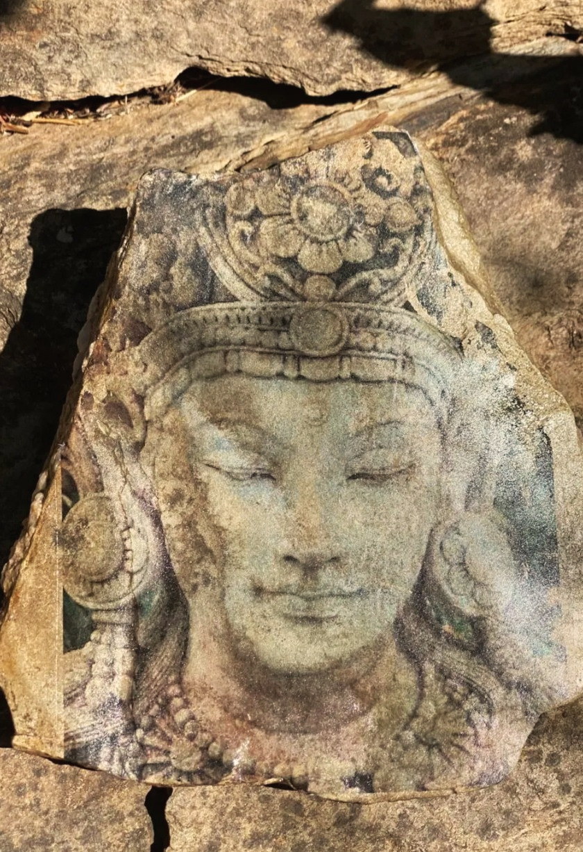 A stoneprint by Jyoti Graziano: the face of a carved deity transferred onto a flat stone