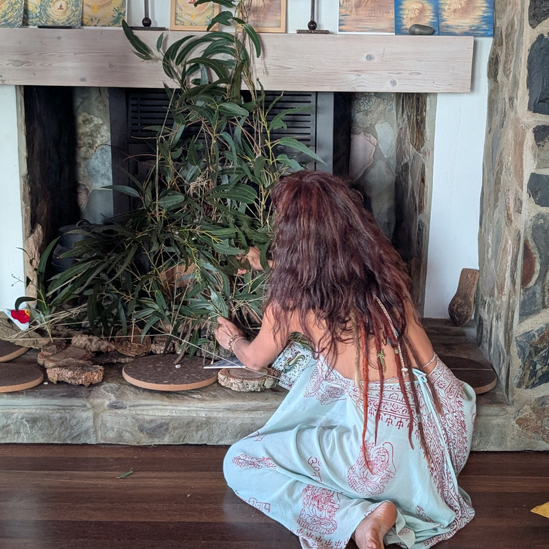 Lucia Maria at work in the studio, her pieces laid out along the mantel