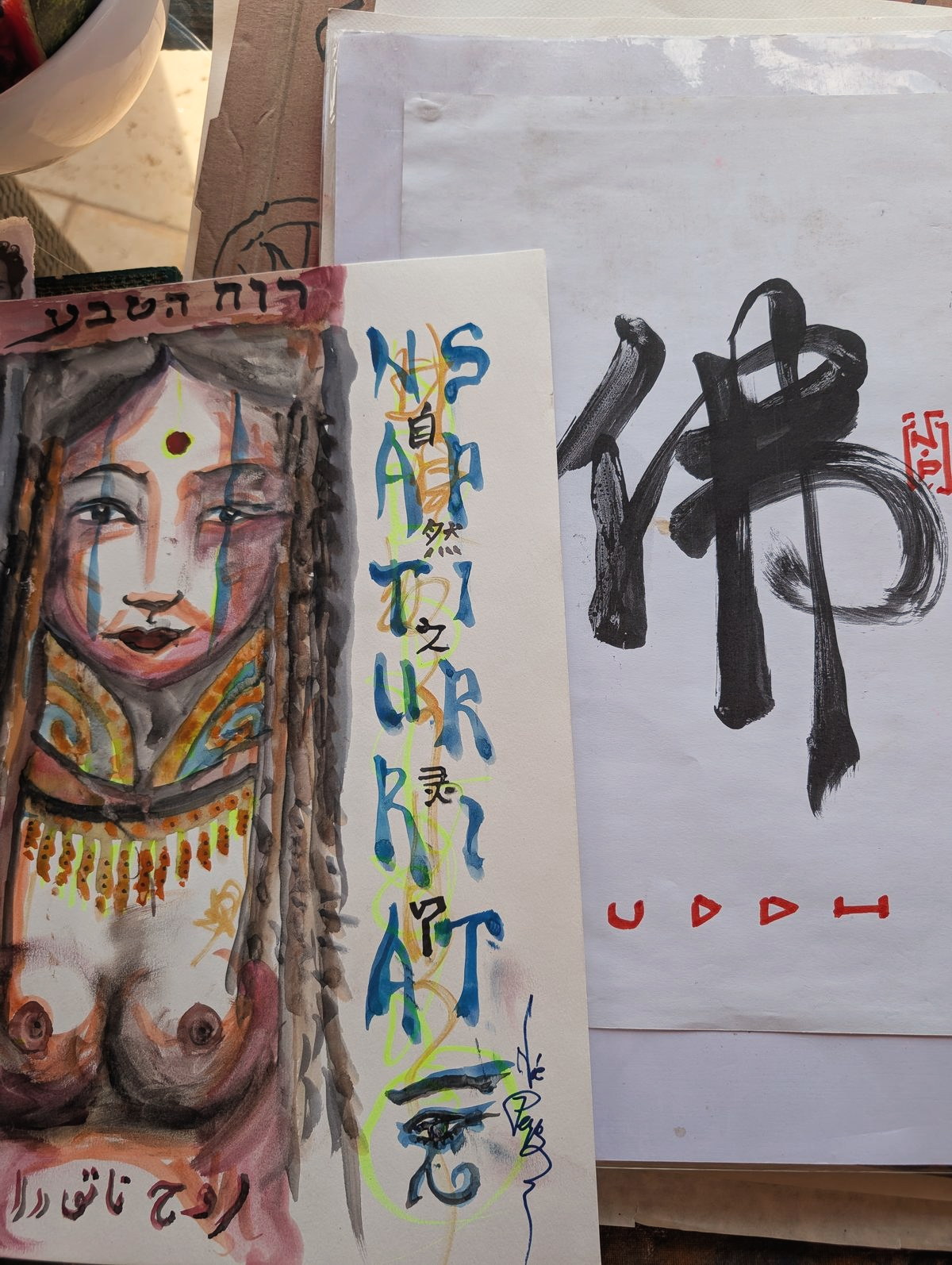 Naturart lettered in invented script beside a brushed Buddha character, by NOAH