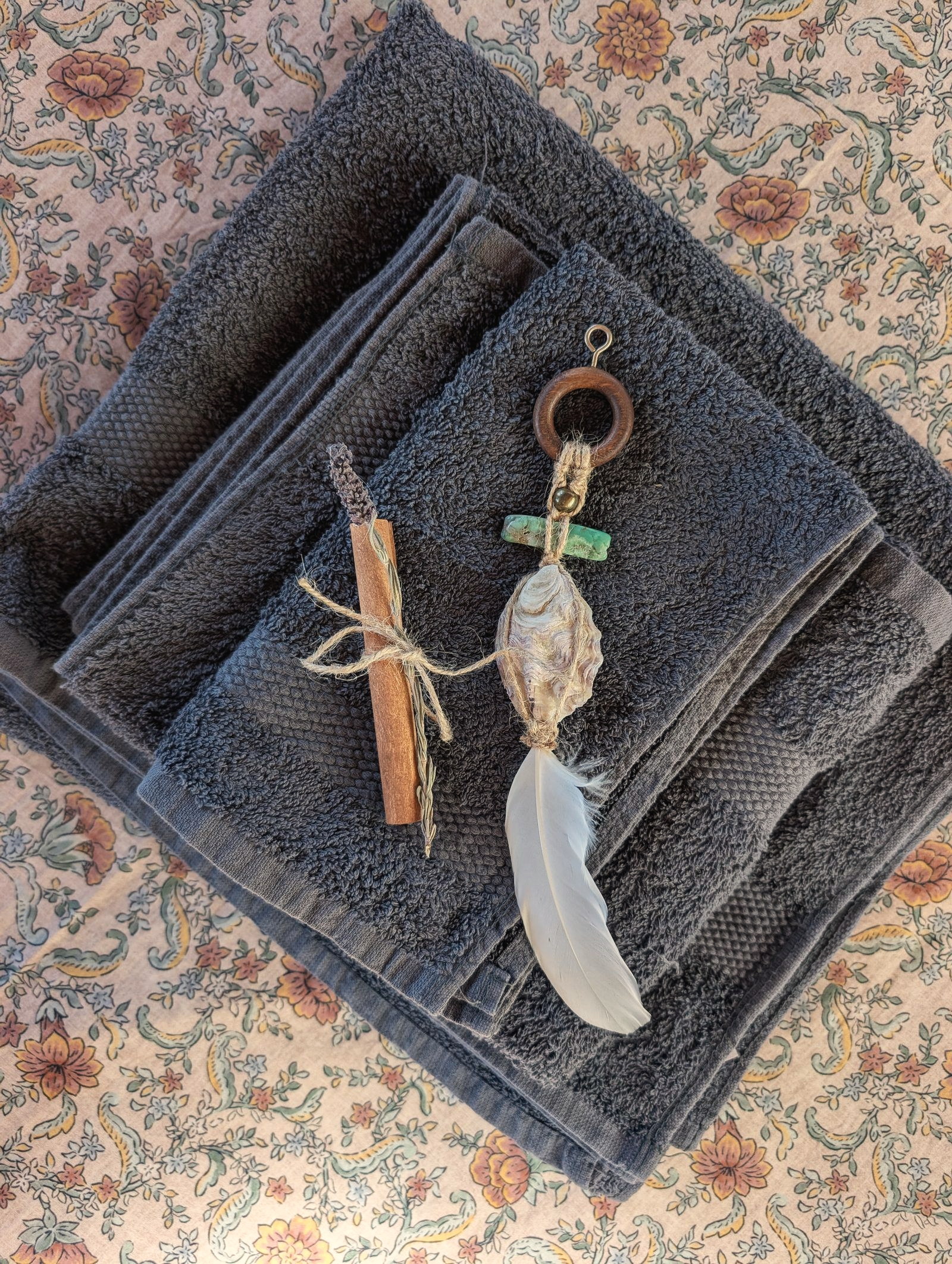 A feather and shell hanging with a smudge stick, by Philine Allard