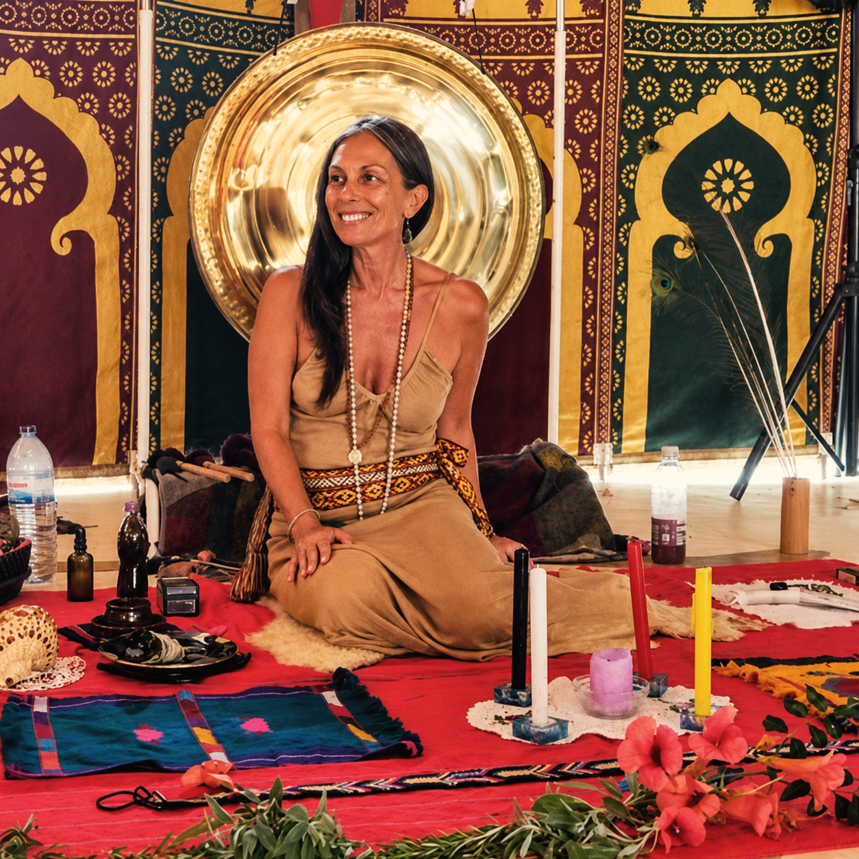 Shankari seated at the ceremonial altar before a gong