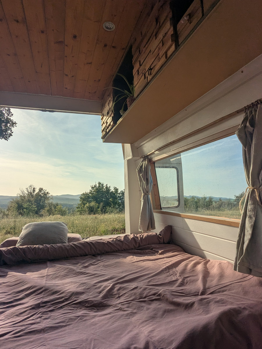 The bed in the van, the fields through the window