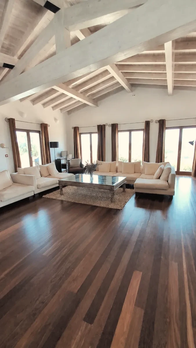 The open living room under a high beamed ceiling